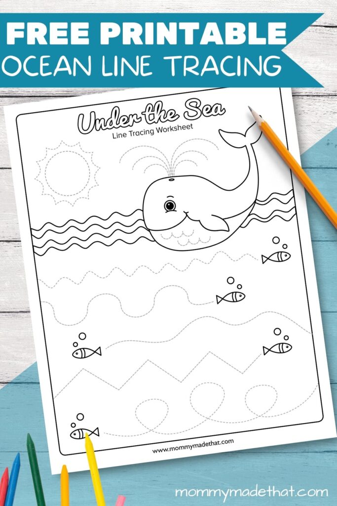 Free printable ocean-themed line tracing worksheet featuring a whale and fish for preschoolers